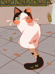 Calico cat with a clipped ear looking behind at the viewer. She is standing on a tiled sidewalk with a concrete barrier in the front of her, with a metal fence on top, holding in greenery.
